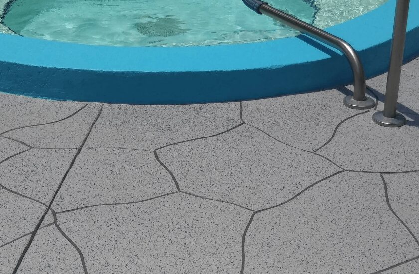 Decorative pool deck next to hot tub