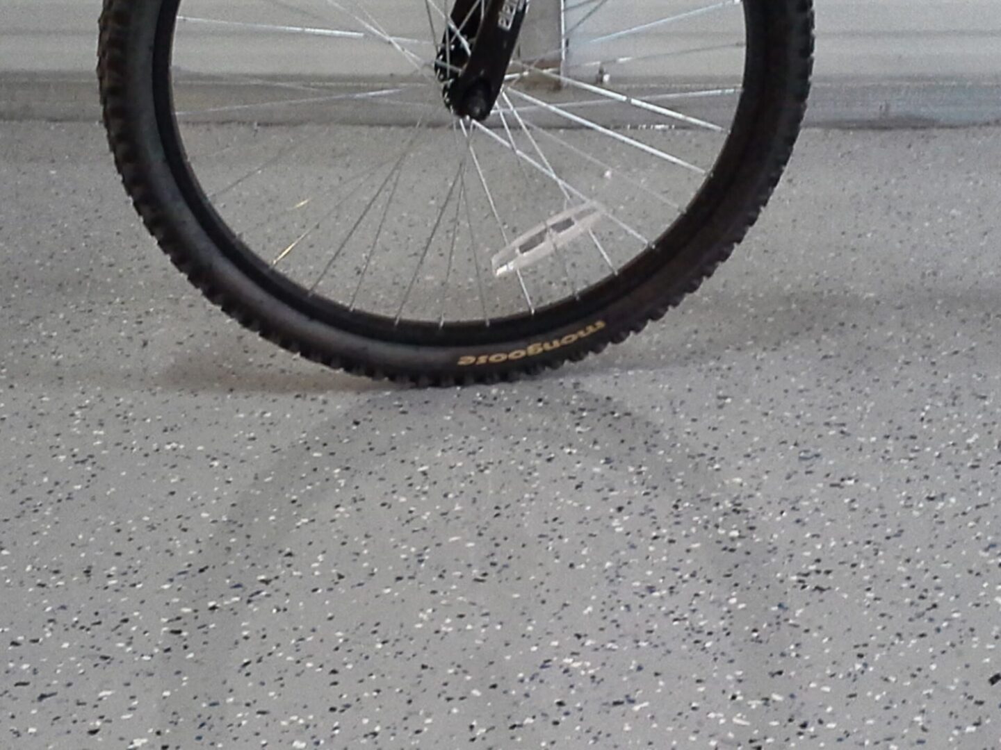 bicycle tire on gray garage floor