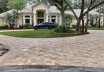 Brick paver circular driveway in front of house